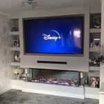 Electric fire media wall with sound bar and alcoves