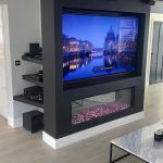Electric fire media wall situated on a black with purple notes