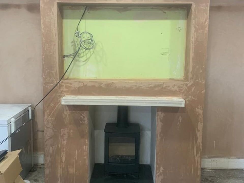 Log burner chimney breast media wall