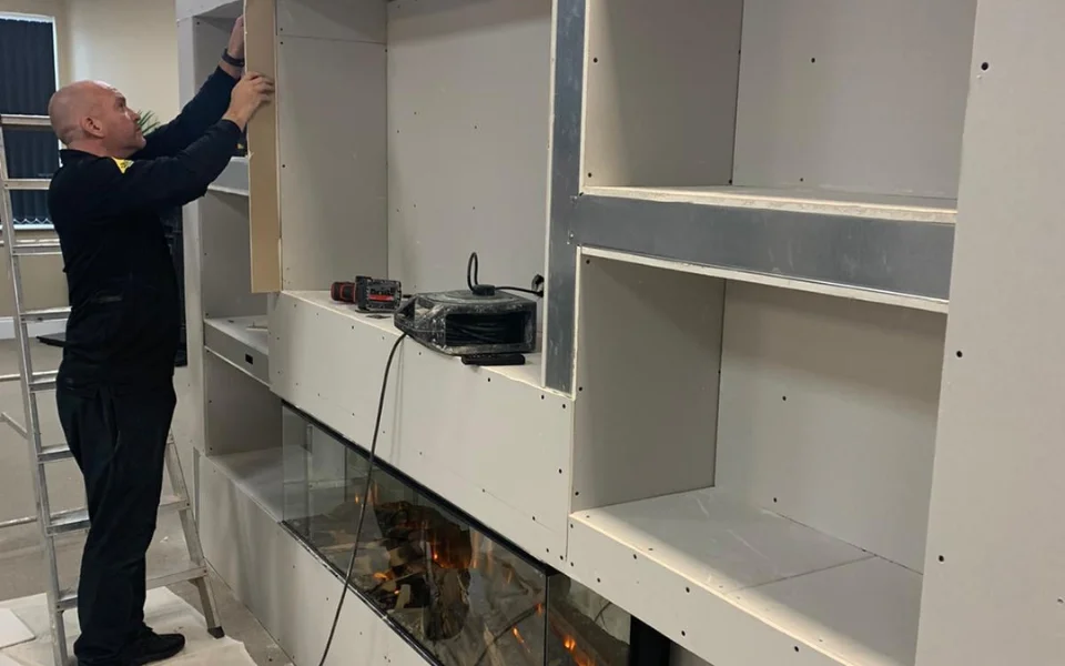 A man building a media wall