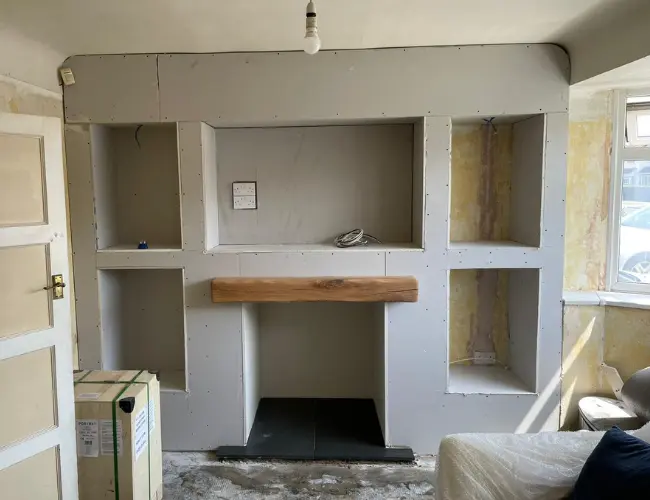 A media wall and log vurner construction