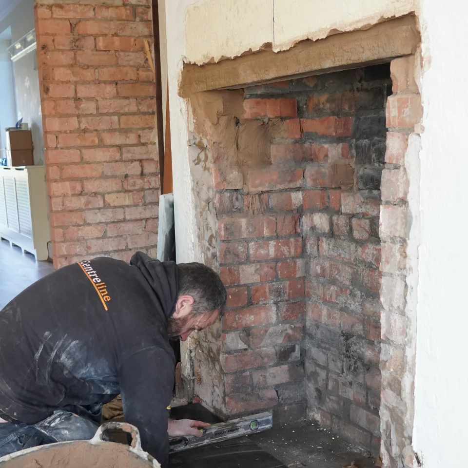 wood burner installer fitting stove - levelling foundation