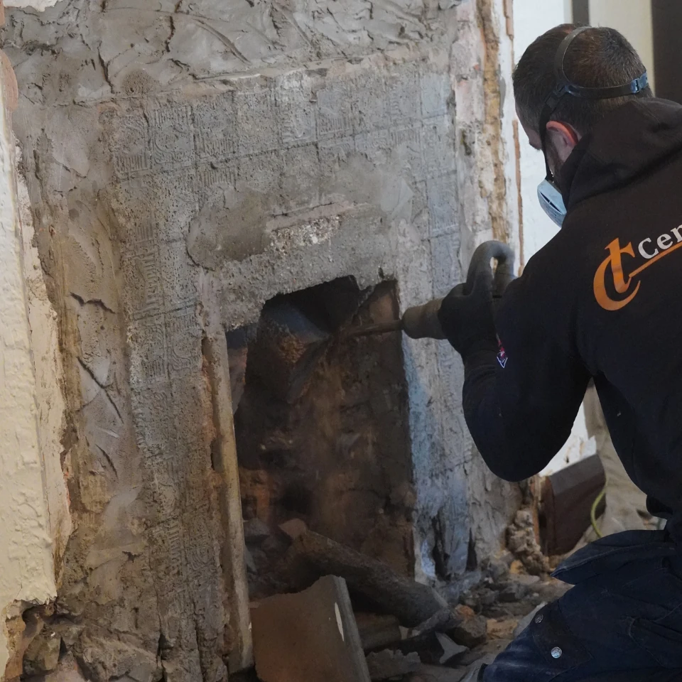 wood burner installer fitting stove - drilling hole