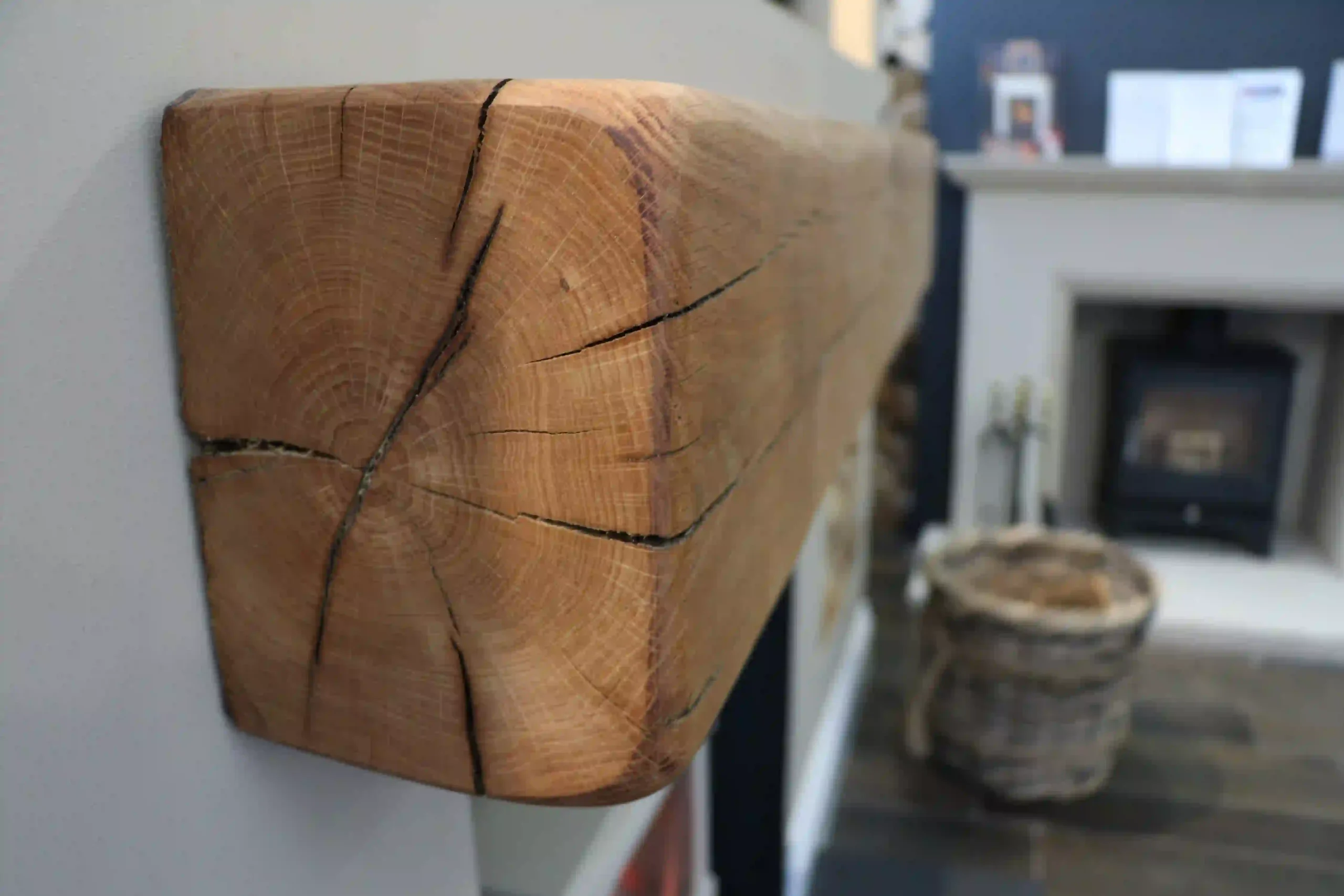 Close up of media wall log burner beam