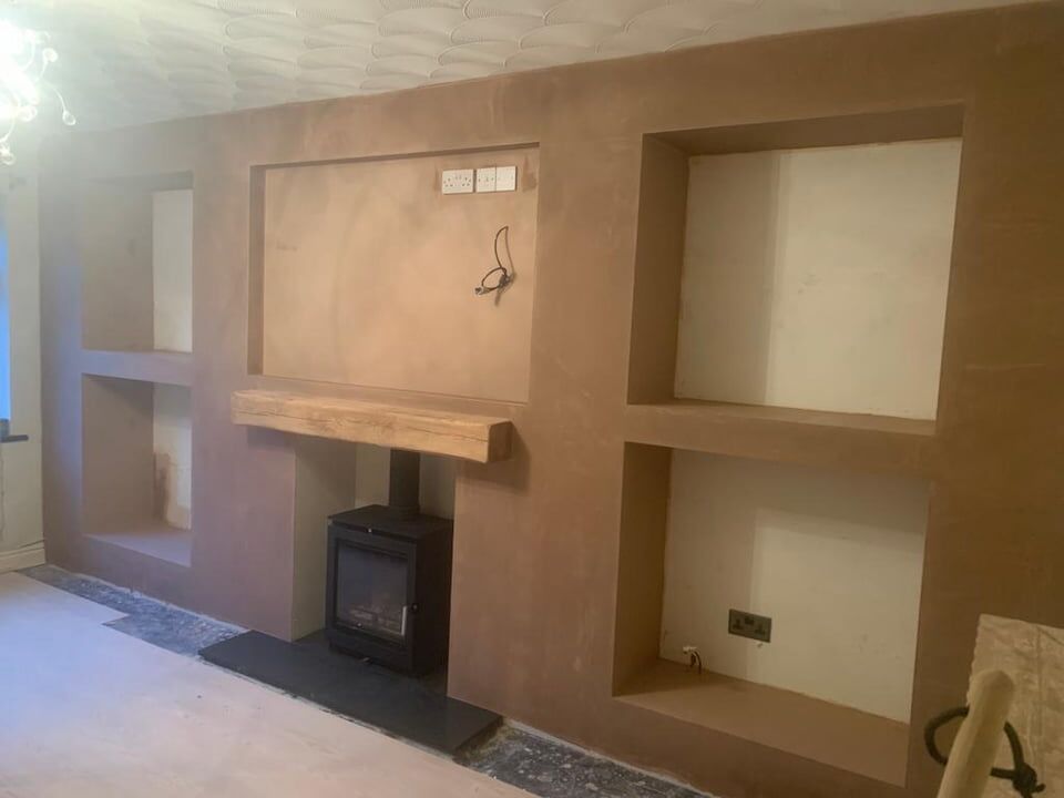 Log burner media wall with shelf alcoves
