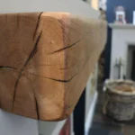 Close up of media wall log burner beam