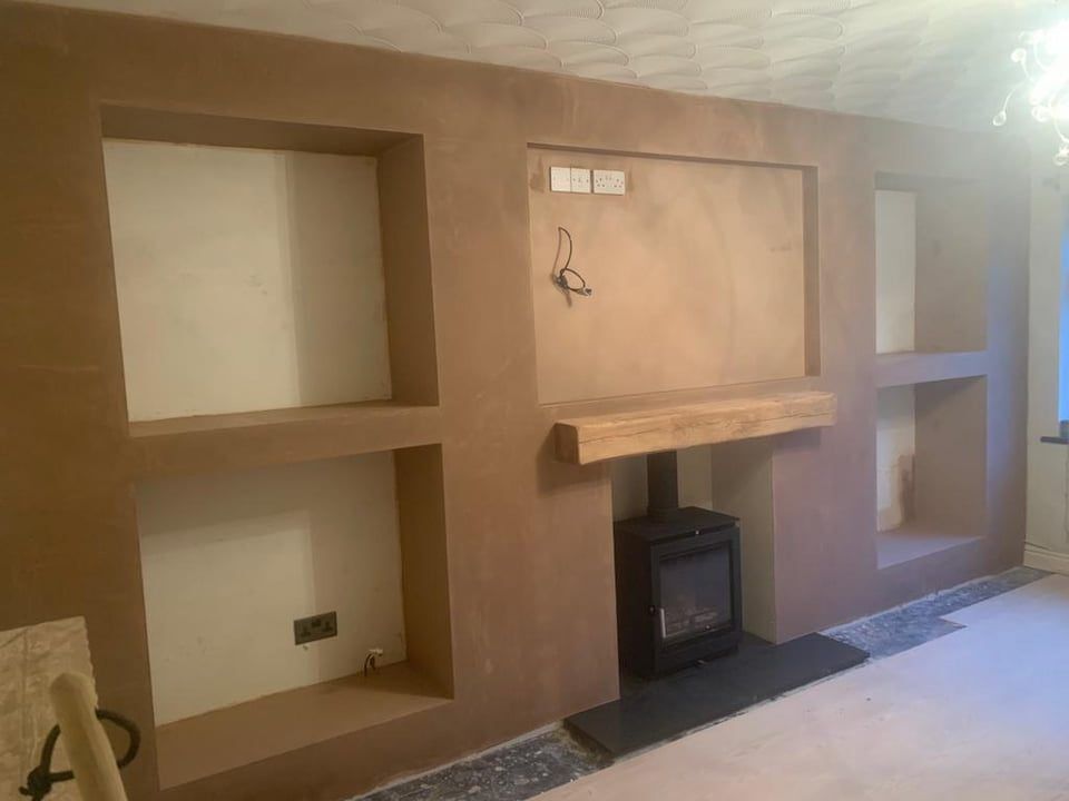 Log burner media wall with shelf alcoves